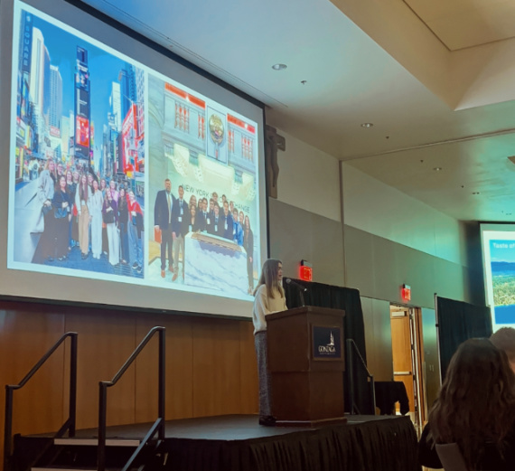 A man hugs his father as his mother and sister look on